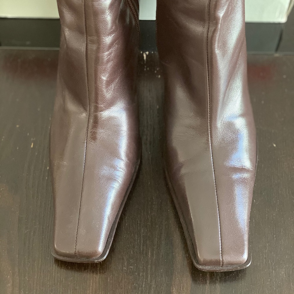 Stylish dark tan tall boots with zipper.